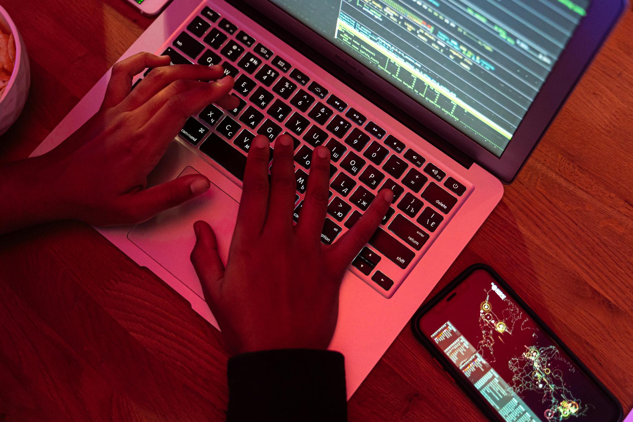 Close-up of a tech-savvy cybersecurity expert working on a laptop to protect digital assets